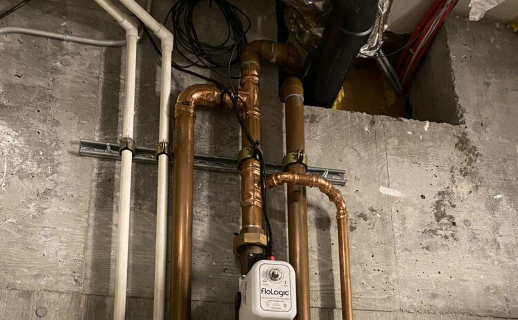 Copper piping manifold with isolation valves on a mechanical wall