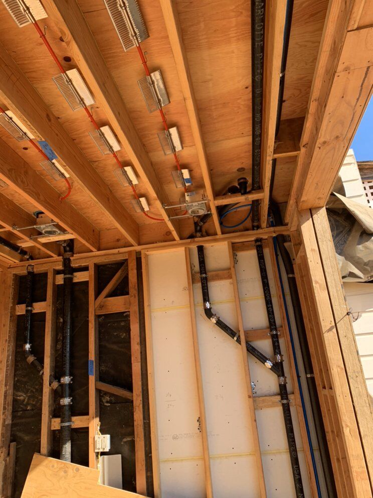 Overhead supply mains routed through a ceiling